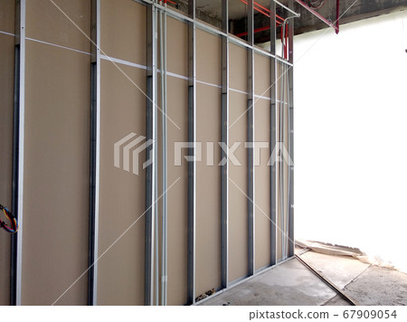 KUALA LUMPUR, MALAYSIA -APRIL 12, 2018: Drywall installation work in progress by construction workers at the construction site. It is the easiest and cheapest way to do partition for the interior wall 67909054
