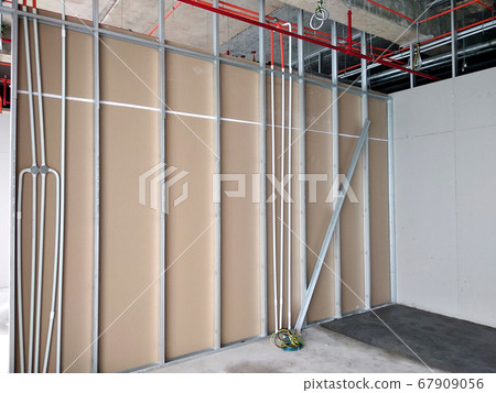 KUALA LUMPUR, MALAYSIA -APRIL 12, 2018: Drywall installation work in progress by construction workers at the construction site. It is the easiest and cheapest way to do partition for the interior wall 67909056