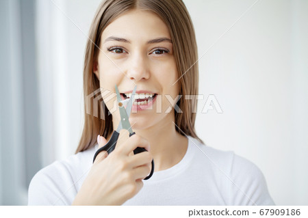 Stop smoking, woman cuts a cigarette with scissors Stop smoking, woman cuts a cigarette with scissors 67909186