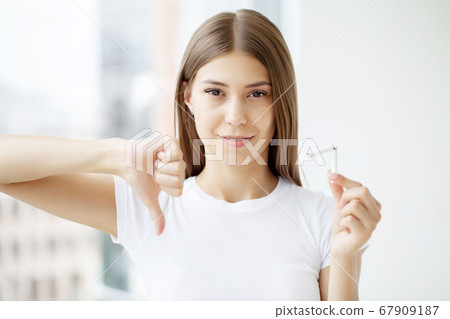 Stop smoking, woman holding a broken cigarette in her hand Stop smoking, woman holding a broken cigarette in her hand 67909187