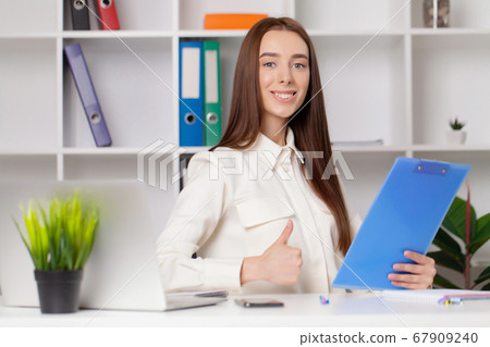Young girl working in a light office 67909240
