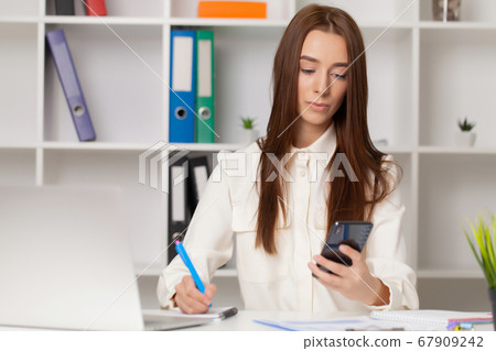 Young girl working in a light office Young girl working in a light office 67909242