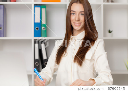 Young girl working in a light office Young girl working in a light office 67909245