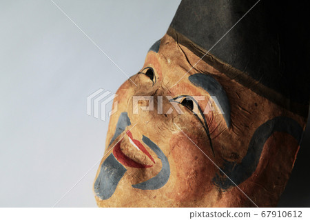 An old man's mask made of paper clay 67910612