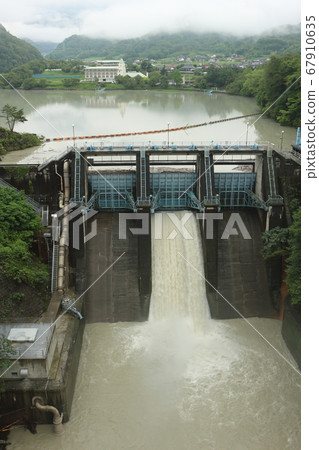 Water flooded by heavy rain, muddy Takato dam and Takato lake 67910635
