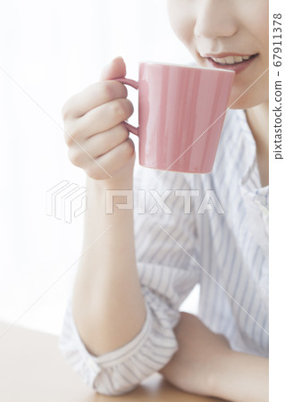 A woman drinking coffee A woman drinking coffee 67911378