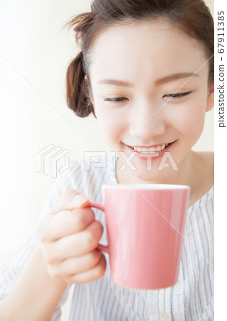 A woman drinking coffee A woman drinking coffee 67911385