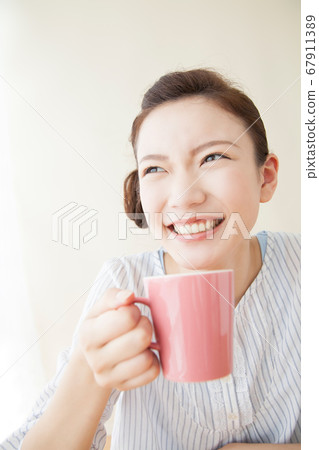 A woman drinking coffee A woman drinking coffee 67911389