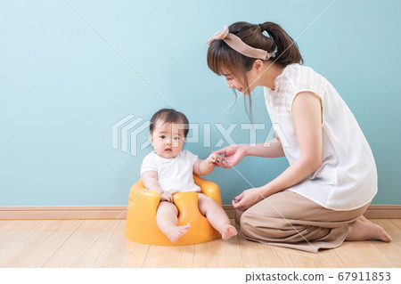 Baby in front of a blue wall Baby in front of a blue wall 67911853