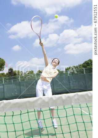 A woman playing tennis A woman playing tennis 67912551