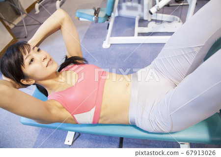 Woman doing muscle training 67913026