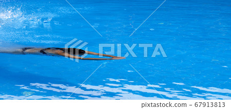 Woman swimming in open air swim pool Woman swimming in open air swim pool 67913813