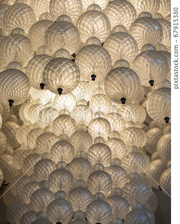 Glowing light bulb hanging from the ceiling hall background.  67915380