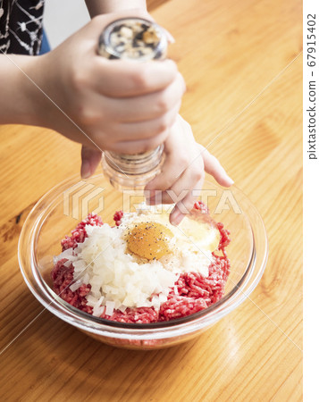 Handmade hamburger seeds ground pepper in a mill Handmade hamburger seeds ground pepper in a mill 67915402