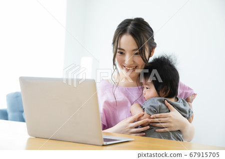 Mother and baby watching personal computer 67915705