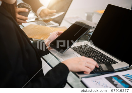 Business team present. professional investor working new start up project. Finance managers meeting.using smart phone and laptop and digital tablet computer in modern office.  67916277