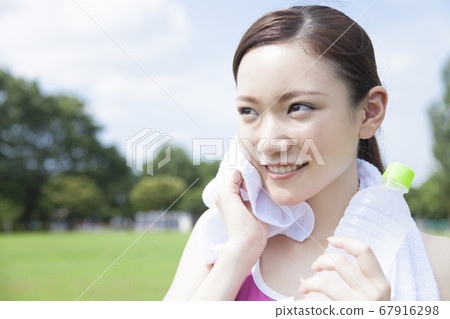 一個女人用毛巾出汗 一個女人用毛巾出汗 67916298