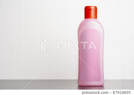 Hair shampoo bottle in front of  light gray 67918605
