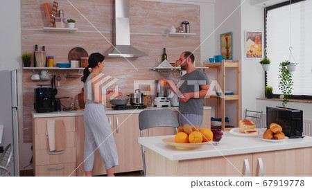 Married couple preparing breakfast Married couple preparing breakfast 67919778