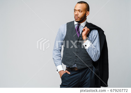 studio shot of a african-american businessman wearing coat over light grey background studio shot of a african-american businessman wearing coat over light grey background 67920772