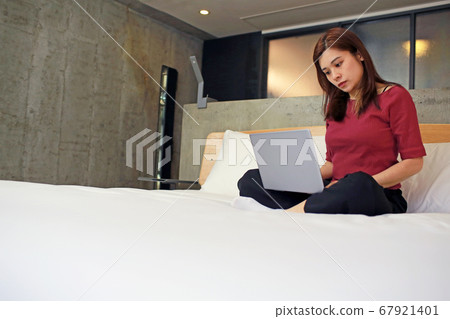 woman work from home on the bed woman work from home on the bed 67921401