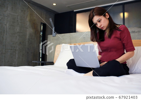woman work from home on the bed woman work from home on the bed 67921403