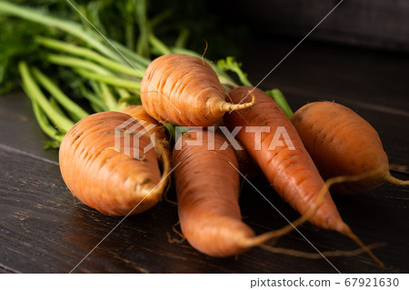 Carrot with green tops close-up Carrot with green tops close-up 67921630