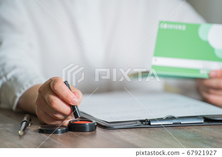 Woman stamping a contract 67921927