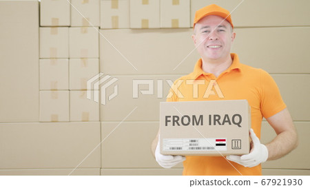 Worker wearing orange uniform holds box with printed FROM IRAQ text and label Worker wearing orange uniform holds box with printed FROM IRAQ text and label 67921930