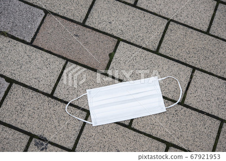 Abandoned mask on the sidewalk Abandoned mask on the sidewalk 67921953