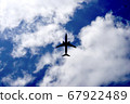 Silhouette of an airplane flying in the sky 67922489