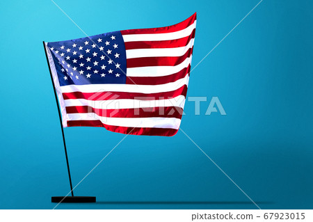 American flag waving in the air with a blue background American flag waving in the air with a blue background 67923015