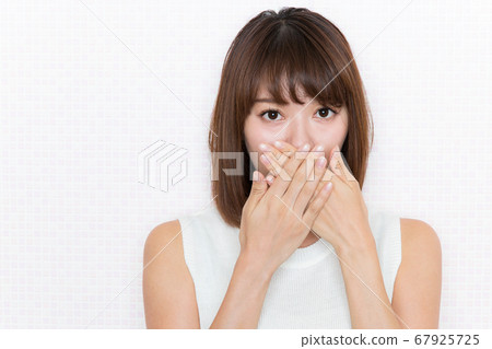 A woman who blocks her mouth. 67925725