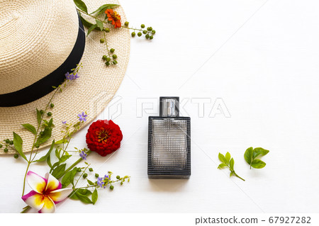 perfume and hat of lifestyle woman relax summer with purple flowers ,zinnia ,frangipani arrangement flat lay style 67927282