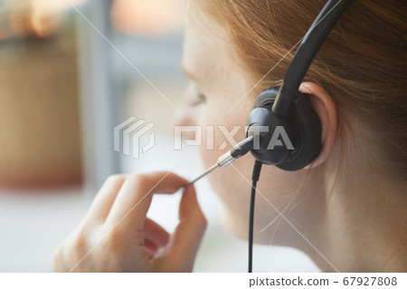 Operator using headphones at work Operator using headphones at work 67927808