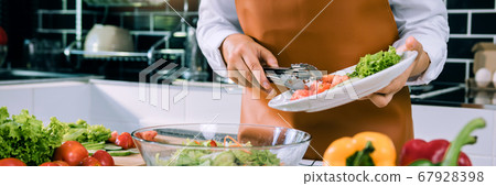Asian woman is pouring ingredients that are Asian woman is pouring ingredients that are 67928398
