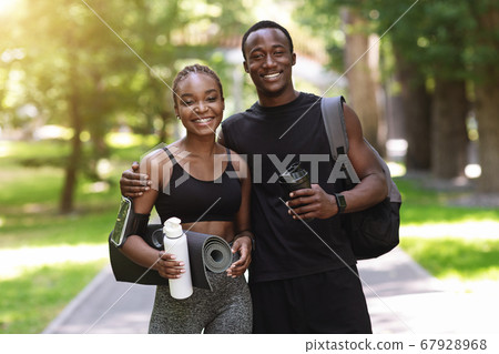 Fit Black Couple In Sportswear Posing Together After Training Outdoors In Park Fit Black Couple In Sportswear Posing Together After Training Outdoors In Park 67928968