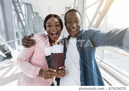 Finally Travelling. Excited African Couple Taking Selfie At Airport With Passports 67929070