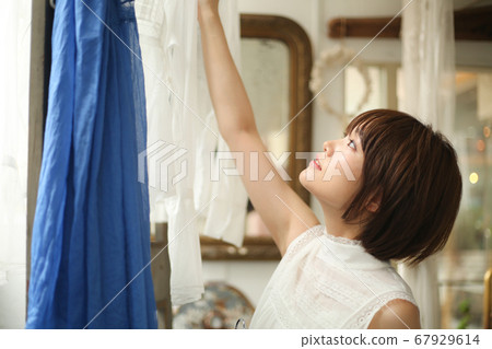 A woman choosing clothes A woman choosing clothes 67929614