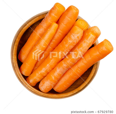 Snack carrots in a wooden bowl. Crunchy and fresh, unpeeled, small and young carrots, ready-to-eat. Edible, raw, organic and vegan. Close-up from above, on white background, isolated macro food photo. Snack carrots in a wooden bowl. Crunchy and fresh, unpeeled, small and young carrots, ready-to-eat. Edible, raw, organic and vegan. Close-up from above, on white background, isolated macro food photo. 67929780