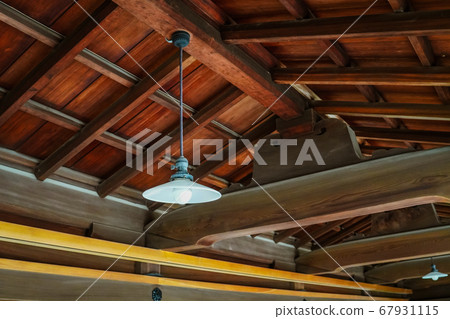 Classic lights hung from a wooden house (glass shade and light bulb) Classic lights hung from a wooden house (glass shade and light bulb) 67931115