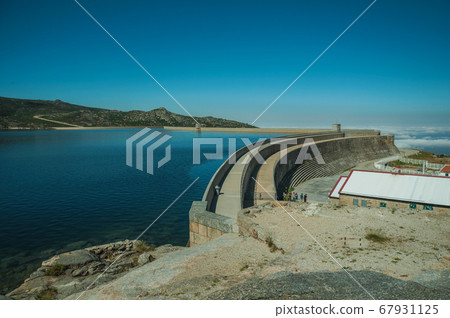 Pathway over dam wall forming a lake on highlands Pathway over dam wall forming a lake on highlands 67931125
