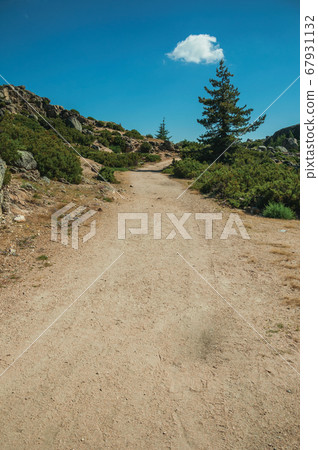 Trail passing through rocky formations on highlands Trail passing through rocky formations on highlands 67931132