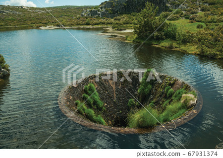 Large sinkhole in a dam lake on the highlands 67931374