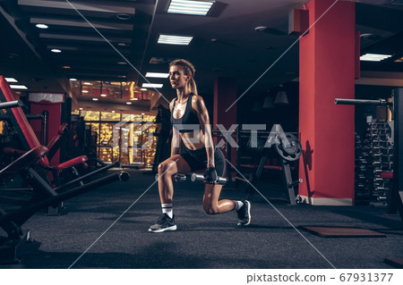 Beautiful young sporty woman training, workout in gym Beautiful young sporty woman training, workout in gym 67931377