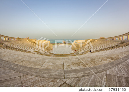 The amphitheater in Katara Cultural Village, Doha Qatar panoramic view in daylight with Arabic gulf in background 67931460