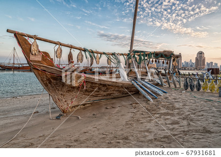Traditional Dhow Festival in Katara cultural village, Doha, Qatar showing old decorated wooden Arabic boats with clouds in the sky in background 67931681