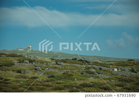 Rocky landscape with bushes and domes of an old radar station on the highlands Rocky landscape with bushes and domes of an old radar station on the highlands 67931690