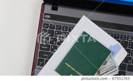 green passport on the keyboard 67931763
