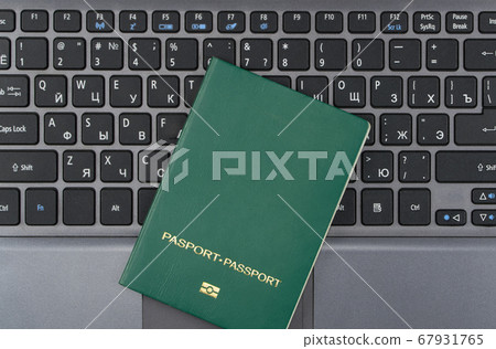 green passport on the keyboard green passport on the keyboard 67931765